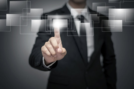 Close up of businessman touching digital screen with finger