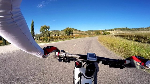 Man on bicycle in a Tuscany countryside. Colors o fa autumn. Origina Point of View