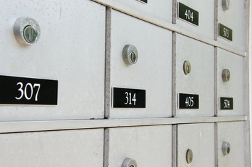 Closeup of locked metal apartment or condominium mailboxes