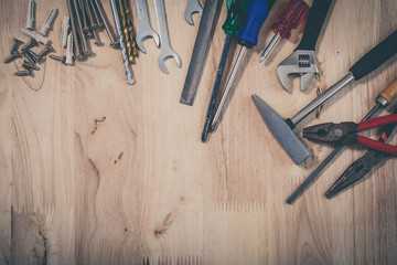 Set of different tools on wooden background