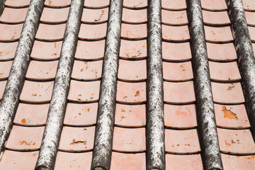 Old tile roof texture. Weathered surface of ancient roof