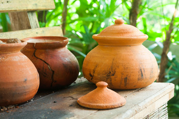 Clay pots or porttery on a shelf  outside kitchen room