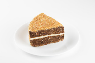 Piece of biscuit cake in a plate isolate on white background