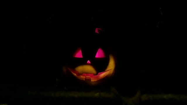 Dark night a lantern in the shape of a pumpkin on Halloween.