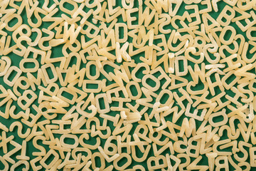 Wooden alphabet letters and numbers on green background