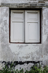 old window in an ancient white brick wall