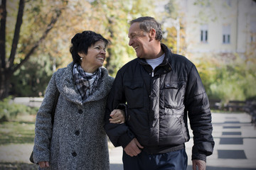 Senior couple enjoying fall in park