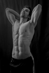 Fototapeta na wymiar Handsome muscular man posing in black and white 