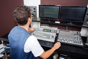 Man Mixing Audio In Recording Studio