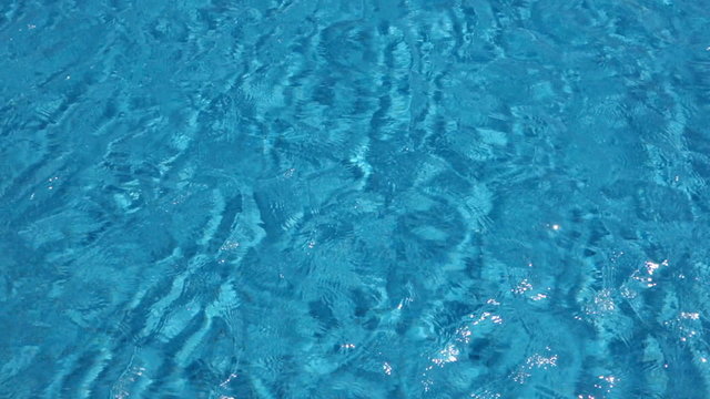 Cool blue wavy water pattern from the surface of a swimming pool