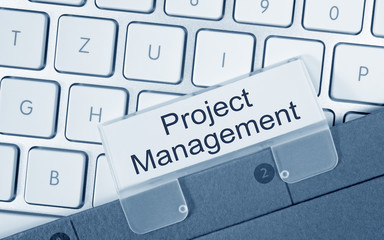 Project Management - folder with text on computer keyboard in the office