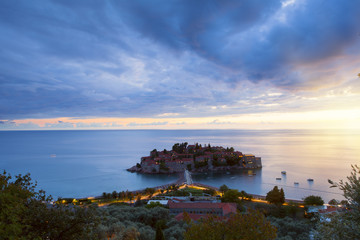 view of beauty sunset over Sveti Stefan, small islet and resort in Montenegro. Balkans, Adriatic sea, Europe.