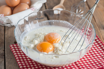 Flour with an eggs and milk in a bowl. Ingredients pancake.