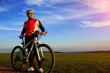 young adult cyclist riding mountain bike in the countryside