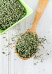 dried thyme on wooden surface