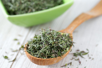 dried thyme on wooden surface