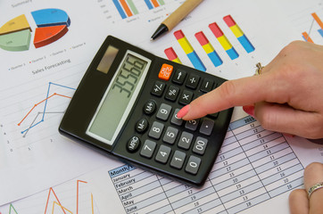 Financial accounting graphs analysis with pen and calculator