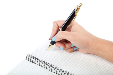 Woman's hand with a pen writing in a notebook.