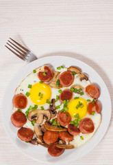 fried eggs with mushrooms and sausage