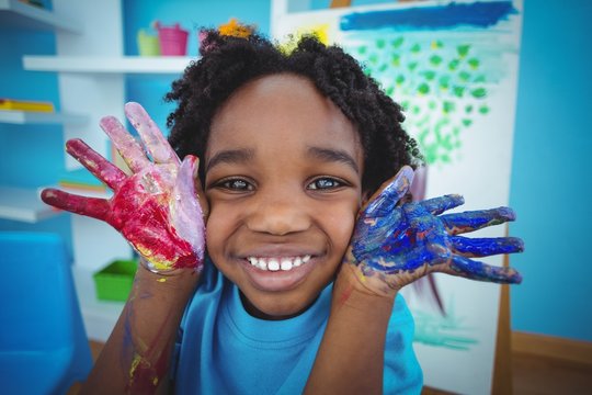 Happy african american kid enjoying arts and crafts painting