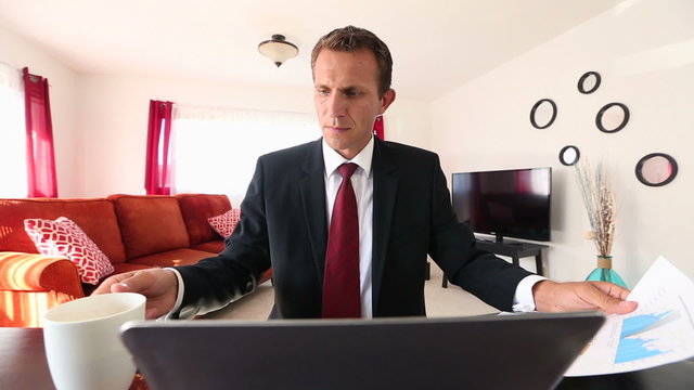 Caucasian Businessman Working on laptop computer at home
