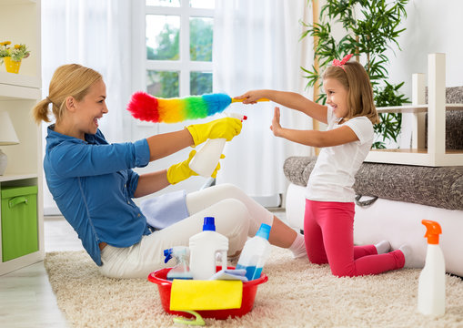 Happy Smiling Mom And Kid Cleaning Room