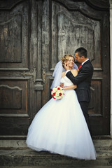 Wedding couple on the background of old wooden door