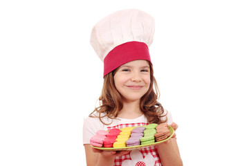 happy little girl cook with macaroons