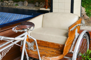 old tricycle with beige leather cushion