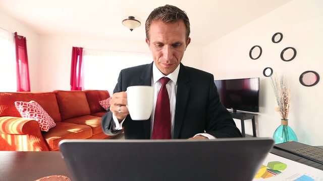 Caucasian Businessman Working on laptop computer at home