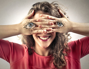 Blind girl with eyes painted on her hands