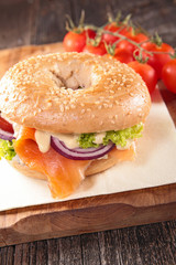 salmon and vegetable on bagel sandwich
