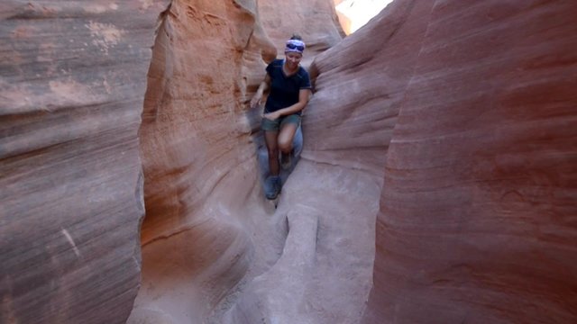 Girl Hiker Climbing Narrow Part of Peekaboo Gulch Canyon