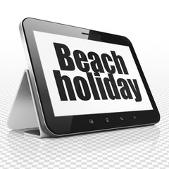 Travel concept: Tablet Computer with Beach Holiday on display