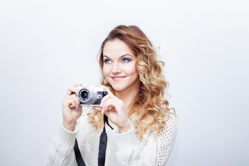 young  woman photographer with camera, portrait on white background