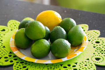Juicy, ripe citrus on the plate - lime and lemon