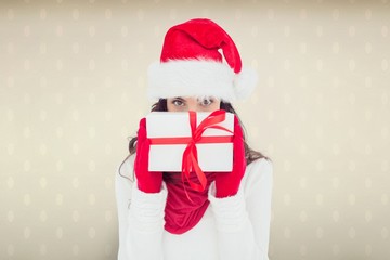 Composite image of brunette in red gloves and santa hat