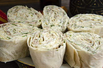Rolls of lavash, saury, cheese, eggs and mayonnaise