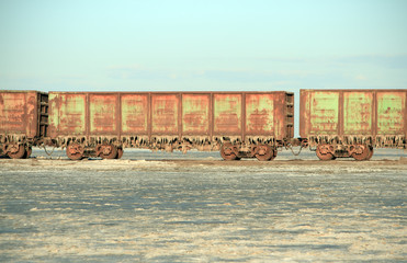 Old rusty train cars with stalactites of salt 