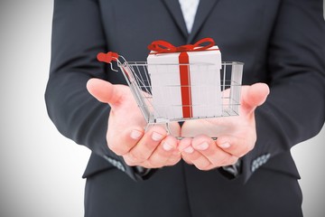 Composite image of businessman holding his hands out