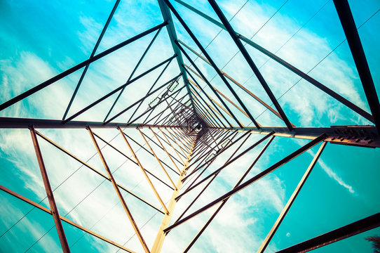 Silhouette shot of electricity pylons with cloudy sky