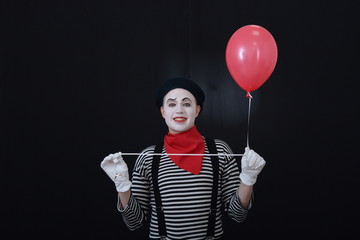 male MIME in white gloves holds airy balls