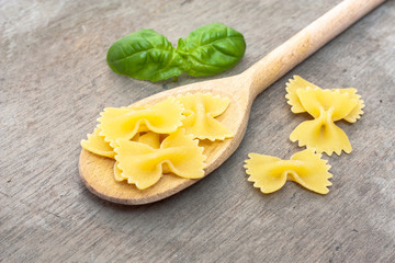 Fine farfalle noodles on wooden board