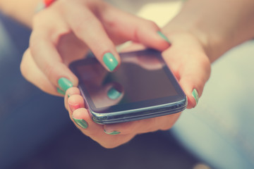 Texting on a smartphone. Shallow depth of field.