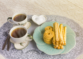 Cups of hot black coffee and cookies on wood table  with sugar in mini lovely heart pattern bowl 