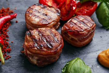Grilled meat fillet steak wrapped in bacon medallions - 95180987