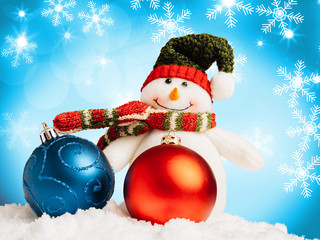 Christmas baubles, snowman and snowflakes on a blue background