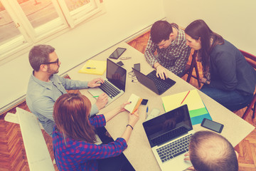 Young group of people discussing business plans.