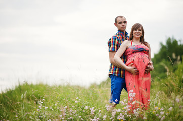Happy young couple expecting baby, pregnant woman with husband