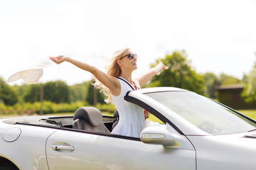 happy man and woman driving in cabriolet car